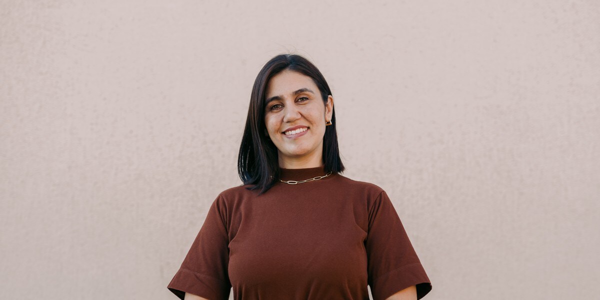 woman smiling with arms crossed